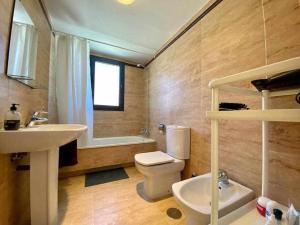 a bathroom with a sink and a toilet and a window at A&N Spacious Family Retreat with Pool & Parking in Torre del Mar +21 photos