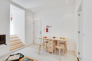 une chambre avec une table, des chaises et un escalier dans l'établissement Alcantara Charm 3BR Apartments, à Lisbonne