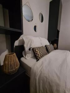 a bedroom with a bed with a mirror on the wall at MAISON AMPERE in Limoges