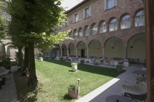 a courtyard with tables and chairs in front of a building at Palazzo Santo Spirito in Bergamo