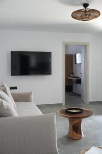 a living room with a couch and a table at Azul Houses Kythnos in Kithnos