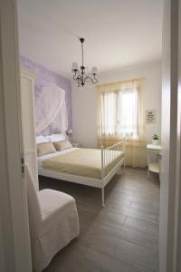 a bedroom with a bed and a chandelier at Venustas in Lampedusa