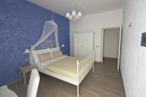 a bedroom with a white bed with a canopy at Venustas in Lampedusa