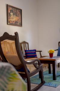 a living room with a rocking chair and a table at Casa Makech in Valladolid
