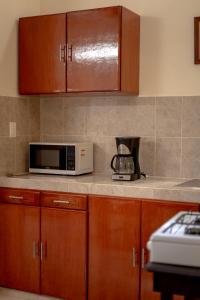 a kitchen with a counter top with a microwave at Casa Makech in Valladolid +18 photos