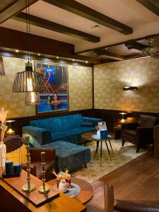 a living room with a blue couch and a table at Hotel Heidelberg in Heidelberg