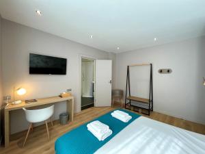 a bedroom with a bed and a desk and a chair at Le Five Tellier - Blossom in Reims