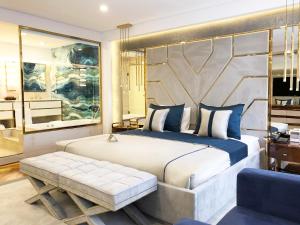 a bedroom with a king sized bed and a bench at AHC Old City Hotel in Istanbul