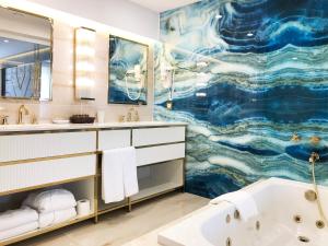 a bathroom with a large painting on the wall at AHC Old City Hotel in Istanbul