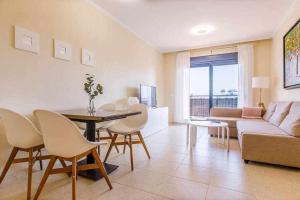 a living room with a couch and a table and chairs at A&N La Vega 11 in Torre del Mar