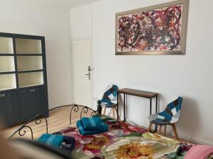 a living room with two chairs and a painting on the wall at BnB Maison d'Art Breakfast in the Art Gallery in Ploubazlanec