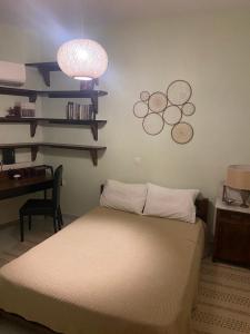 a bedroom with a bed and a desk and a lamp at Liberty porosview apartement in Galatas