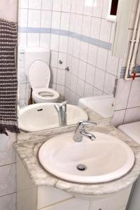a bathroom with a sink and a toilet at CASA Sarajevo Apartment in Sarajevo