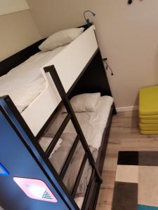 a bed in a room with a bunk bed at Apartament PORTA MARE 115 Wes Quality Suite in Dziwnówek