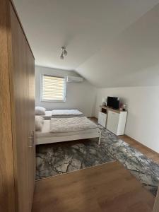a bedroom with a bed and a window at Apartmani Jezero in Konjic