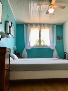 a bedroom with a large bed with a window at Maison 90 m2, 5 min du Port, 15 min des Criques à Pied in Port-Vendres