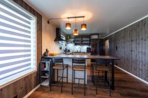 a kitchen with a table and chairs in a room at Lofoten Green Studio in Ramberg