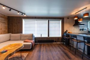 salon z kanapą i kuchnią w obiekcie Lofoten Green Studio w mieście Ramberg