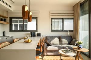 a kitchen and living room with a couch at Balcony Bar Skyline View by Sea N' Rent in Tel Aviv