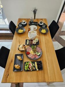 uma mesa de madeira com pratos de comida em Houston Resort em Radovljica