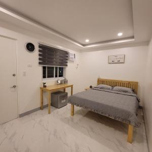 莫阿爾博阿的住宿－TuloMir #C 뚤로미르 행복한 2인실，一间卧室配有一张床、一张书桌和一个窗户。