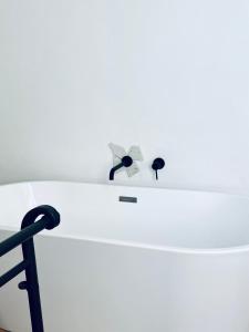 a white table with a chair and a clock on it at Il Bottone al Duomo in Gaeta
