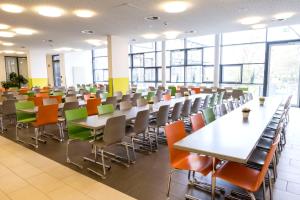 an empty lecture room with tables and chairs at Jugendherberge Hamburg Horner Rennbahn in Hamburg