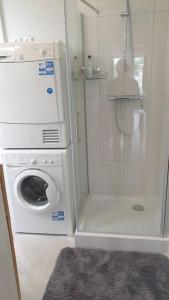 a washer and dryer in a small bathroom at Amsterdam - Bright, canal-side, central, renovated 1BR in Amsterdam
