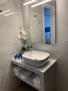 a bathroom with a sink and a mirror and towels at Ocean Blue Suites in Ierissos