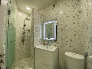 a bathroom with a toilet and a sink and a shower at Comfort Home in Tbilisi City
