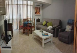 a living room with a couch and a table at Piso Granada in Granada