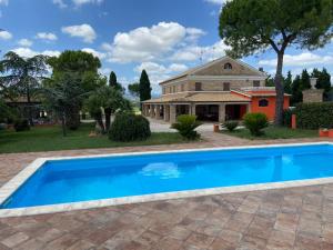 a swimming pool in front of a house at Casale Monte Amato in Tornasano