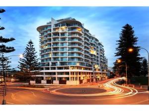 a large building on a city street at night at Liberty bay holiday Spacious two bedroom, two bathroom with sea views in Glenelg