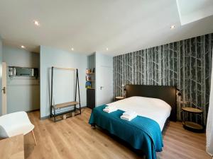 a bedroom with a bed and a mirror in it at Le Five Tellier - Forest in Reims