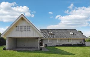a large white house with a garage at Three-Bedroom Holiday Home In Knebel in Knebel