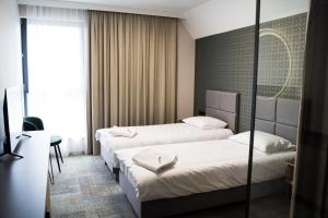 a hotel room with two beds and a desk at BULVAR in Malbork