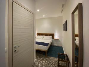 Postel nebo postele na pokoji v ubytování Taffetà b&b