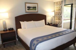 a bedroom with a large bed with two nightstands and two lamps at Innisbrook Resort in Palm Harbor