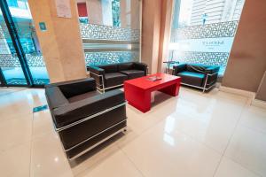 a waiting room with couches and a red table at Mérit San Telmo by Amérian in Buenos Aires +26 photos