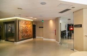 a lobby of a building with a large painting on the wall at Mérit San Telmo in Buenos Aires