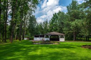 a picnic shelter in a park with green grass at Mercure Wiazowna Brant in Wiązowna