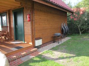 a porch of a house with a grill on it at Delightful Holiday Home in Lubin with Garden in Międzyzdroje