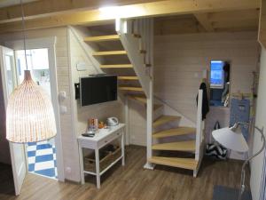 a tiny house with a staircase and a desk at Delightful Holiday Home in Lubin with Garden in Międzyzdroje