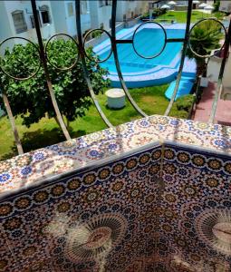 a view of a bench with a pool in the background at Suit Home in Martil
