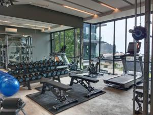 a gym with a lot of exercise equipment and windows at Bo304-Panorama Seaview 1 Bedroom at Ao Nang Beach in Ao Nang Beach