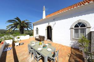a patio with a table and a house at Vale Formoso-authentic Farmhouse &pool-tavira 3km in Tavira