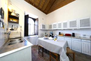 a kitchen with a table and a sink in it at Vale Formoso-authentic Farmhouse &pool-tavira 3km in Tavira