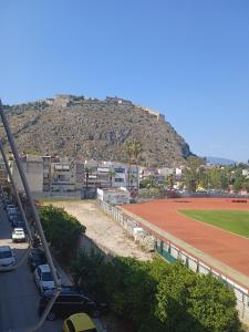 a view of a baseball field with a hill in the background at Sofias Home in Nafplio