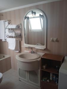 a bathroom with a sink and a mirror at Sofias Home in Nafplio