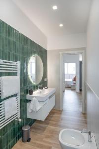 La salle de bains est pourvue d'un lavabo, de toilettes et d'un miroir. dans l'établissement Attico 70 - Puteoli Apartament, à Pouzzoles